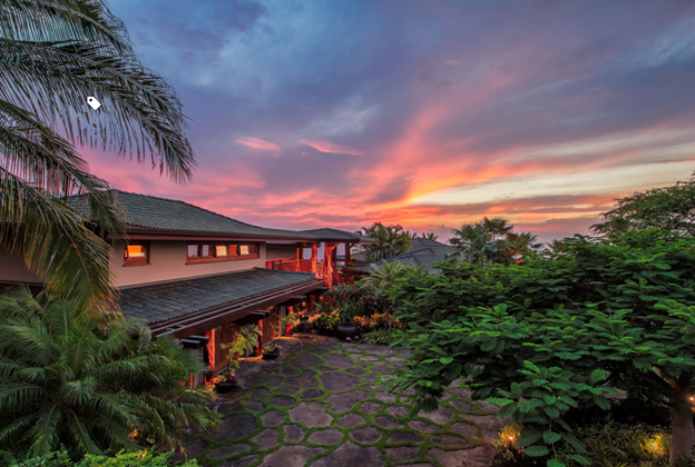 Custom home from Hawaii Island Architects lit up at night